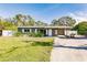 Ranch-style home with a carport and green lawn at 3214 Amanda St, Punta Gorda, FL 33950