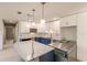 Modern kitchen featuring white and blue cabinets, marble countertops, and stainless steel appliances at 3214 Amanda St, Punta Gorda, FL 33950