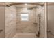 Elegant shower with marble tile, a rainfall shower head, and built-in shelving at 3214 Amanda St, Punta Gorda, FL 33950