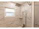 Clean shower with marble tile, a rainfall shower head, and built-in shelving at 3214 Amanda St, Punta Gorda, FL 33950