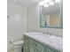 Bathroom with light green vanity and marble countertop at 3310 Loveland Blvd # 1604, Punta Gorda, FL 33980