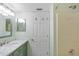 Bathroom with light green vanity, marble countertop, and shower at 3310 Loveland Blvd # 1604, Punta Gorda, FL 33980