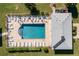 Community pool with surrounding lounge chairs at 3310 Loveland Blvd # 1604, Punta Gorda, FL 33980