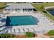 Community pool area with lounge chairs and surrounding fence at 3310 Loveland Blvd # 1604, Punta Gorda, FL 33980