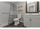 Bathroom with walk-in shower, toilet, and vanity at 3450 Moravia Ave, North Port, FL 34286