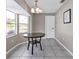 Bright dining room featuring a round dark wood table and window seat at 3450 Moravia Ave, North Port, FL 34286