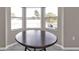 Dining area with a round table and bay window offering natural light at 3450 Moravia Ave, North Port, FL 34286