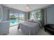 Bedroom with pool view and sliding glass doors at 3723 Tripoli Blvd, Punta Gorda, FL 33950