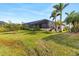 Landscaped backyard with screened enclosure at 3937 Bal Harbor Blvd, Punta Gorda, FL 33950