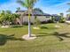 Landscaped backyard with palm trees and solar panels at 3937 Bal Harbor Blvd, Punta Gorda, FL 33950