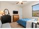 Bedroom with blue bedding, dresser, and a desk at 3937 Bal Harbor Blvd, Punta Gorda, FL 33950