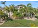 Large home exterior with palm trees and manicured lawn at 3937 Bal Harbor Blvd, Punta Gorda, FL 33950