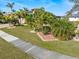 Landscaped front yard with palm trees and walkway at 3937 Bal Harbor Blvd, Punta Gorda, FL 33950