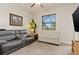 Gathering room with grey reclining sofa, off-white loveseat and large TV at 3937 Bal Harbor Blvd, Punta Gorda, FL 33950