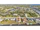 Aerial view of a canal-front home with pool and boat dock, surrounded by other houses at 4107 Rock Creek Dr, Port Charlotte, FL 33948