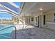 Relaxing pool area with covered patio and canal views at 4107 Rock Creek Dr, Port Charlotte, FL 33948