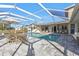 Relaxing pool area with covered patio, lounge chairs, and outdoor dining set at 4107 Rock Creek Dr, Port Charlotte, FL 33948