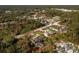 Aerial view of a single Gathering home with a pool, nestled in a wooded neighborhood at 4198 Kinlock St, North Port, FL 34286