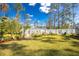 Landscaped backyard with a white fence and garden at 4198 Kinlock St, North Port, FL 34286