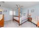 Bright bedroom with a post bed, ceiling fan, and ample space at 4198 Kinlock St, North Port, FL 34286