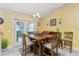 Bright dining area with a wooden table and access to backyard at 4198 Kinlock St, North Port, FL 34286