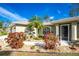 Front entryway with a palm tree and stone landscaping at 4198 Kinlock St, North Port, FL 34286