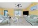 Living room featuring two sofas and a large TV at 4198 Kinlock St, North Port, FL 34286