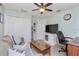 Home office with desk, couch, and large screen TV at 4198 Kinlock St, North Port, FL 34286