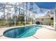 Inviting kidney-shaped pool with screened enclosure at 4198 Kinlock St, North Port, FL 34286