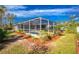 Relaxing screened pool area with lush landscaping at 4198 Kinlock St, North Port, FL 34286