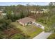 Aerial view of single-story house with driveway and surrounding landscape at 4258 Mermell Cir, North Port, FL 34291