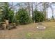 Spacious backyard with lush landscaping and fire pit at 4258 Mermell Cir, North Port, FL 34291