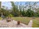 Landscaped backyard with fire pit and tropical plants at 4258 Mermell Cir, North Port, FL 34291