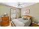 Comfortable bedroom with wood dresser and ceiling fan at 4258 Mermell Cir, North Port, FL 34291