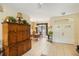 Bright and spacious entryway with double doors and wooden cabinet at 4258 Mermell Cir, North Port, FL 34291