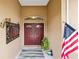 Double front doors with a decorative mirror and American flag at 4258 Mermell Cir, North Port, FL 34291