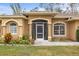 Front entrance with a screened porch and well-maintained landscaping at 4258 Mermell Cir, North Port, FL 34291