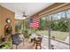 Relaxing screened porch with seating and ceiling fan at 4258 Mermell Cir, North Port, FL 34291