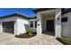 Modern home's front entrance with covered porch and paver walkway at 432 Gun Cay Ln, Punta Gorda, FL 33950