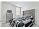 Bedroom with gray upholstered headboard and striped bedding at 43783 Cattleman Dr, Punta Gorda, FL 33982