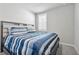 Bedroom with blue striped bedding and window with shutters at 43783 Cattleman Dr, Punta Gorda, FL 33982