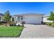 One-story home with gray exterior, two-car garage, and landscaped front yard at 43783 Cattleman Dr, Punta Gorda, FL 33982