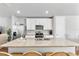 Granite kitchen island with double sinks and a view into the dining area at 43783 Cattleman Dr, Punta Gorda, FL 33982