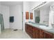 Bathroom with double vanity, large mirror and tiled floor at 4401 Boeing Ln, North Port, FL 34287