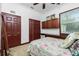 Bedroom with floral bedding and built-in wood cabinets at 4401 Boeing Ln, North Port, FL 34287