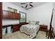 Bedroom with floral bedding and built-in wood cabinets at 4401 Boeing Ln, North Port, FL 34287