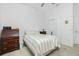 Bedroom with striped bedding, wood furniture, and double doors at 4401 Boeing Ln, North Port, FL 34287