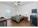 Main bedroom with patterned bedding and wood furniture at 4401 Boeing Ln, North Port, FL 34287