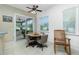 Bright breakfast nook with table and chairs, access to screened porch at 4401 Boeing Ln, North Port, FL 34287