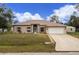 Single-story home with a spacious driveway and well-maintained lawn at 4401 Boeing Ln, North Port, FL 34287